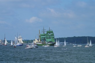 Beautiful view of many sailing boats and a striking green sailing ship Alexander von Humbold 2 in