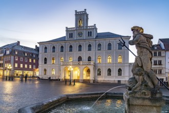 The town hall and Neptune fountain on the market square at dusk, Weimar, Thuringia, Germany
