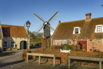 Traditional houses and windmill of the inhabited former fortress of Bourtange, Groningen,