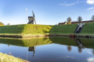 Moat and trestle windmill of the inhabited former fortress of Bourtange, Groningen, Netherlands
