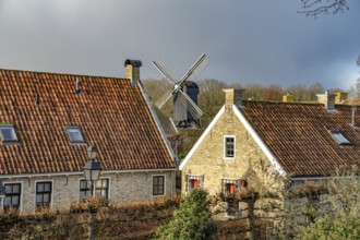 Traditional houses and windmill of the inhabited former fortress of Bourtange, Groningen,