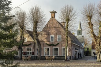 Traditional houses and the small church in the inhabited former fortress of Bourtange, Groningen,