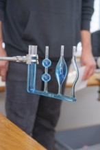 Blue-filled glass tubes in a laboratory for a scientific experiment, Youth Research Centre