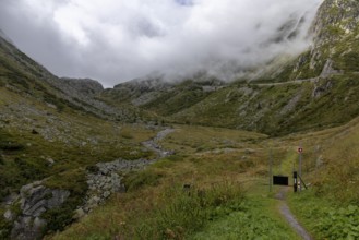 Fog, hiking trail at the Gotthard Pass, right pass road, Hospental, Uri, Switzerland