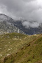 Wind turbines on the Gotthard Pass in the clouds, view from Passo Scimfuss, Airolo, Ticino,