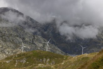 Wind turbines on the Gotthard Pass in the clouds, view from Passo Scimfuss, Airolo, Ticino,