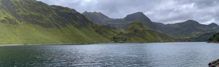 Lago Ritom panorama, right Passo del Sole and Passo dell'Uomo, left road on the lakeshore, Airolo,