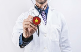Vietnam healthcare system, doctor holding stethoscope. Vietnam health and medical insurance concept