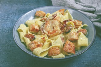 Papardelle pasta in creamy sauce with seafood, homemade, no people