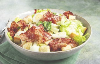 Caesar salad with fried bacon, quail eggs, homemade, no people
