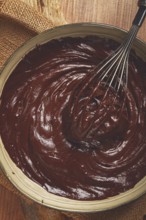 A bowl of chocolate dough, a whisk for whipping, baking, structure and consistency, homemade, top