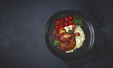 Fried duck shank, cauliflower puree, cherry tomatoes, homemade, no people