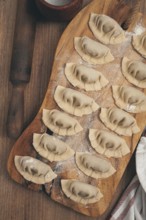 Gyoza cooking, on a cutting board, gyoza Japanese dumplings, top view, selective processing, raw