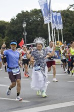A runner with the flag of the People's Republic of China on the Great Star at the 51st BMW Berlin