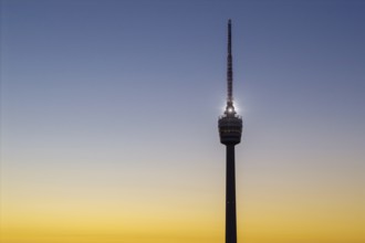 Close-up view of a television tower in front of a colourful sky at sunrise, Stuttgart,