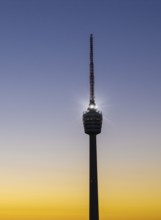 Details of an illuminated television tower at sunrise with a purple sky, Stuttgart,