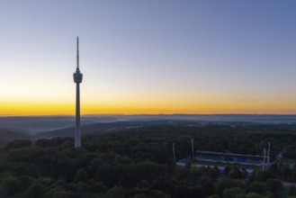 Expansive landscape with television tower and forests in the evening light of sunrise, Stuttgart,