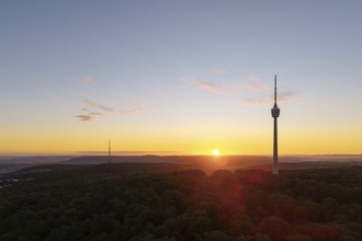 A new day begins with a television tower rising above a forest at sunrise, Stuttgart,
