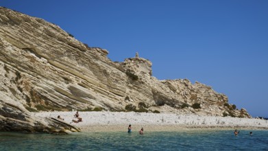 Rocky coast with people walking along the beach and swimming in the sea, White Cliffs, White Beach,