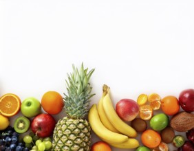 An artistic arrangement of vibrant fruits including apples, oranges, strawberries, and berries on a