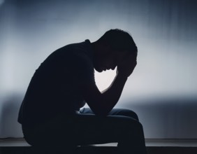 Silhouette of Sad Depressed man sitting. embodying deep despair and hopelessness, AI generated