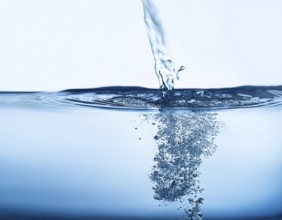 High-quality image showing a splash of water pouring into a clean surface, symbolizing freshness,