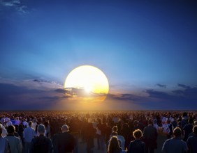 A group of individuals walks along the ground, silhouetted by a large setting sun, creating a