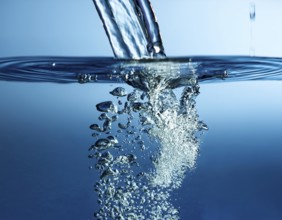 High-quality image showing a splash of water pouring into a clean surface, symbolizing freshness,