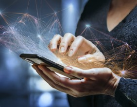 A close-up of a hand using a smartphone with a glowing digital network overlay, illustrating