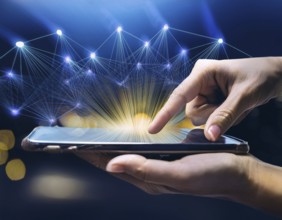 A close-up of a hand using a smartphone with a glowing digital network overlay, illustrating