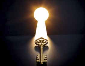 An antique key, leading to a bright light in a keyhole shape, symbolizing opportunity, access, and