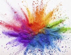 Vibrant and energetic multicolored powder explosion captured against awhite background. Evoking