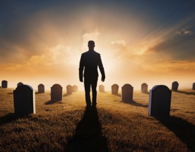 A silhouette of a lone figure walking off a gravestone, The scene evokes Resurrection thoughts