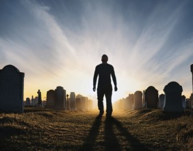 A silhouette of a lone figure walking off a gravestone, The scene evokes Resurrection thoughts