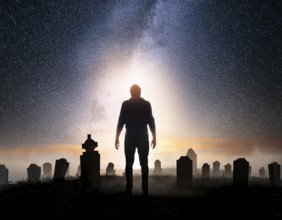 A silhouette of a lone figure walking off a gravestone, The scene evokes Resurrection thoughts