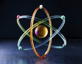 A vibrant illustration of an atomic structure with colorful spheres and connections, illuminated