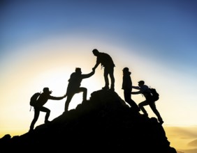 A dynamic depiction of teamwork and determination, climbers ascend a rugged mountain peak during