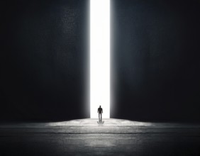 A lone figure stands in a minimalist setting, emphasizing scale, solitude, and illumination. The