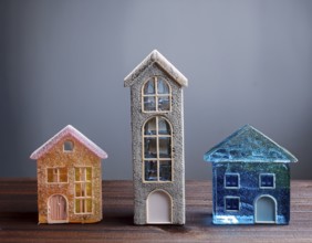 A collection of small glass model houses with cozy lighting, creating a warm and inviting