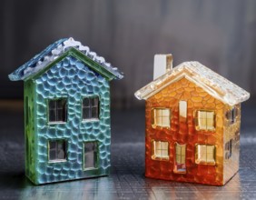 A collection of small glass model houses with cozy lighting, creating a warm and inviting