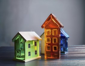 A collection of small glass model houses with cozy lighting, creating a warm and inviting