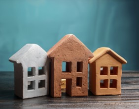 A collection of small model houses with cozy lighting, creating a warm and inviting atmosphere, AI