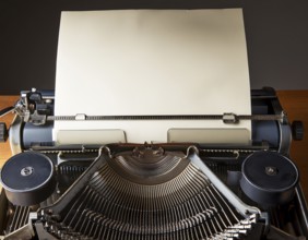 View from above of a retro typewriter equipped with a blank paper sheet, representing creativity,