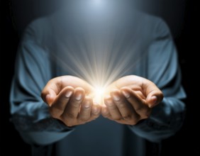 Individual Worship at Home. Image of open hands embracing a radiant light source, embodying
