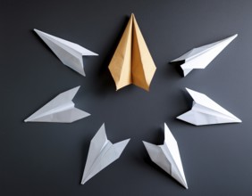 Six colorful origami paper airplanes are displayed in a creative arrangement on a bright