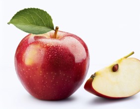 Close-up of a vibrant red apple with a green leaf and a sliced half, showcasing its glossy texture
