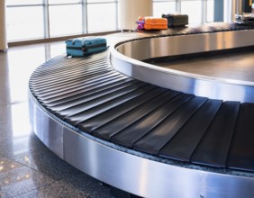 Baggage on a conveyor belt at an airport providing a travel and departure theme, AI generated