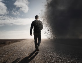 Creative image showing a silhouette of a man merging with an abstract dispersion effect and