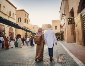 Travelers walk through an scanic architecture and culture of Muslim country, AI generated