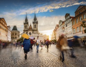 Historical city square with iconic architecture, cobblestone streets, and vibrant motion of